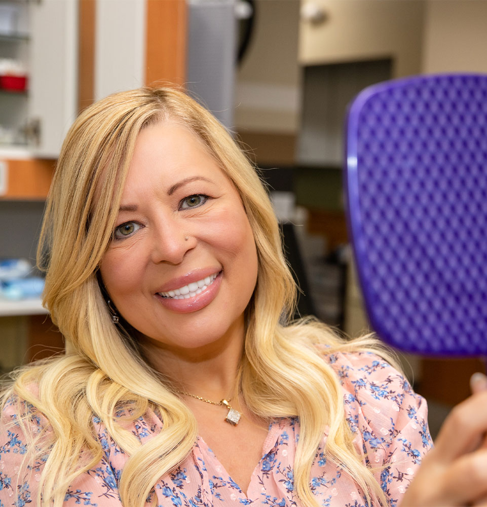 Patient smiling confidently after their dental procedure