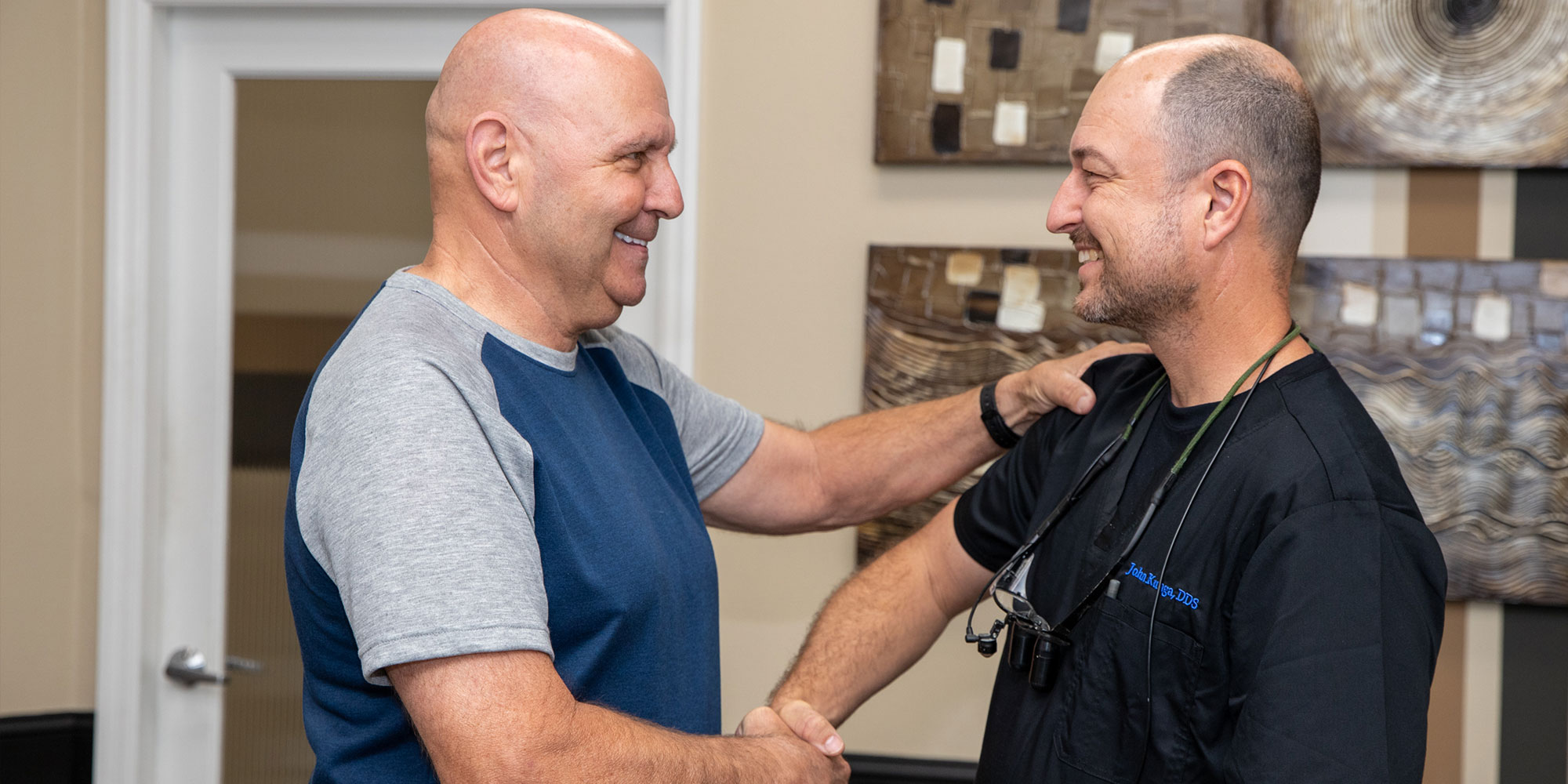 patient shaking hands of doctor after their dental procedure