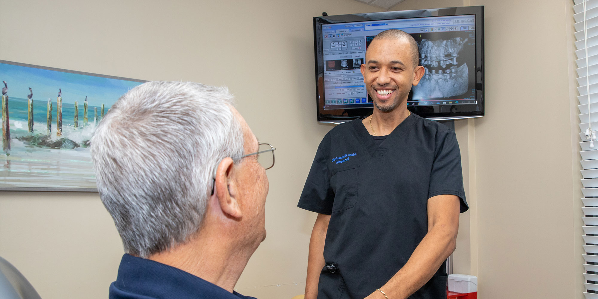 patient shaking hands with doctor after patient's dental procedure