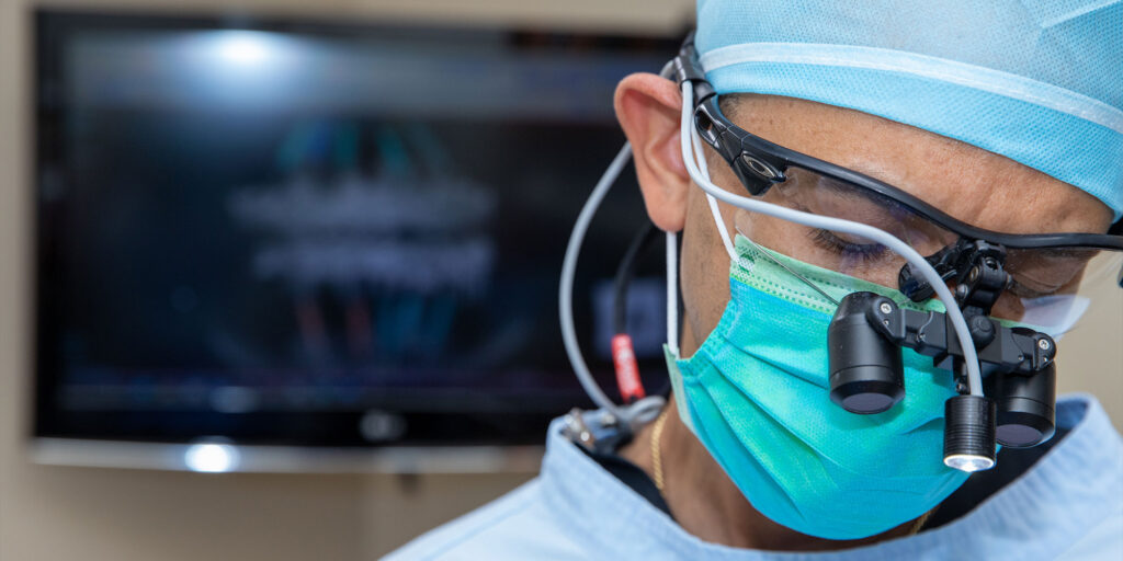 doctor performing dental guided procedure with patient