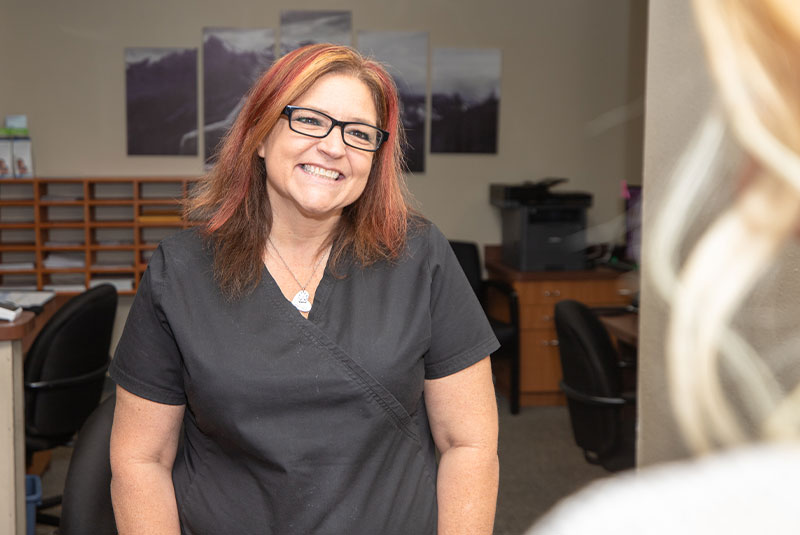 staff member helping patient at the front desk